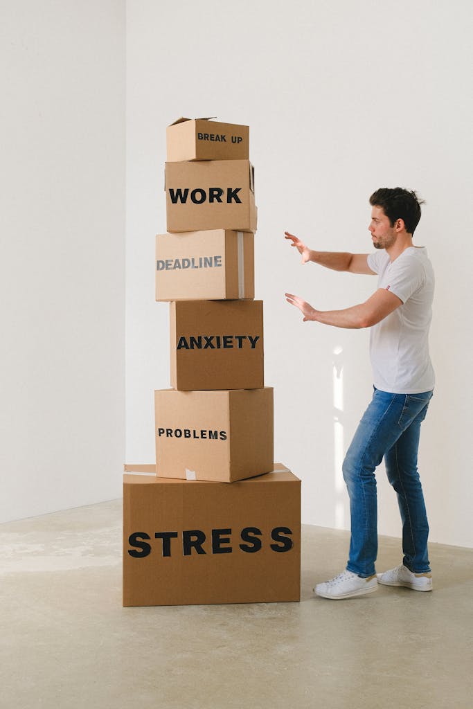 The Overwhelming Reality of Excel CRM Management. A stressed businessman balancing multiple boxes representing the overwhelming challenges of managing customer relationships with Excel spreadsheets.